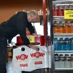 Co-owner Mitch Hebert of Sequims Grocery Outlet places biodegradable bags at the end of a check stand for customers to purchase. The business charges 15 cents per bag as an alternative to plastic, single-use carry-out bags, which the business also offers for free. Hebert said, if customers put a value on their bags, theyre more likely to reuse them. Sequim Gazette photo by Matthew Nash