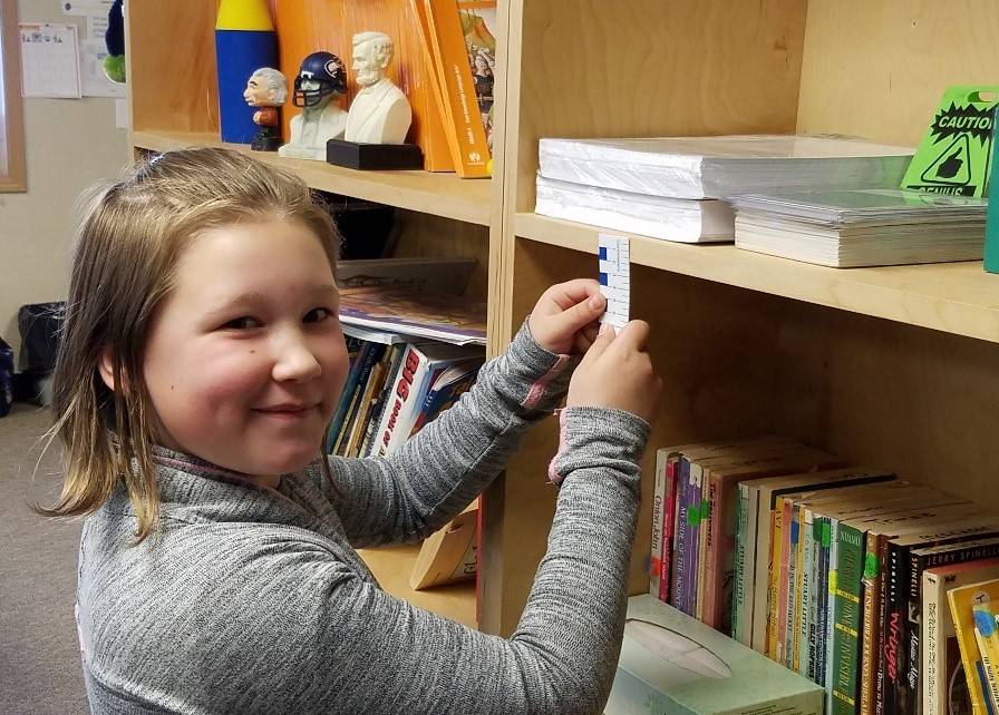 Harper Moore, a fourth-grade student at Helen Haller Elementary, practices using fractions. Submitted photo