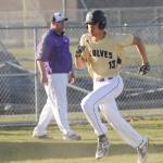 As Sequim coach Dave Ditlefsen looks on, SHSs Hayden Eaton rounds third base and scores late in the Wolves 10-1 win over North Mason on March 20. Sequim Gazette photo by Michael Dashiell
