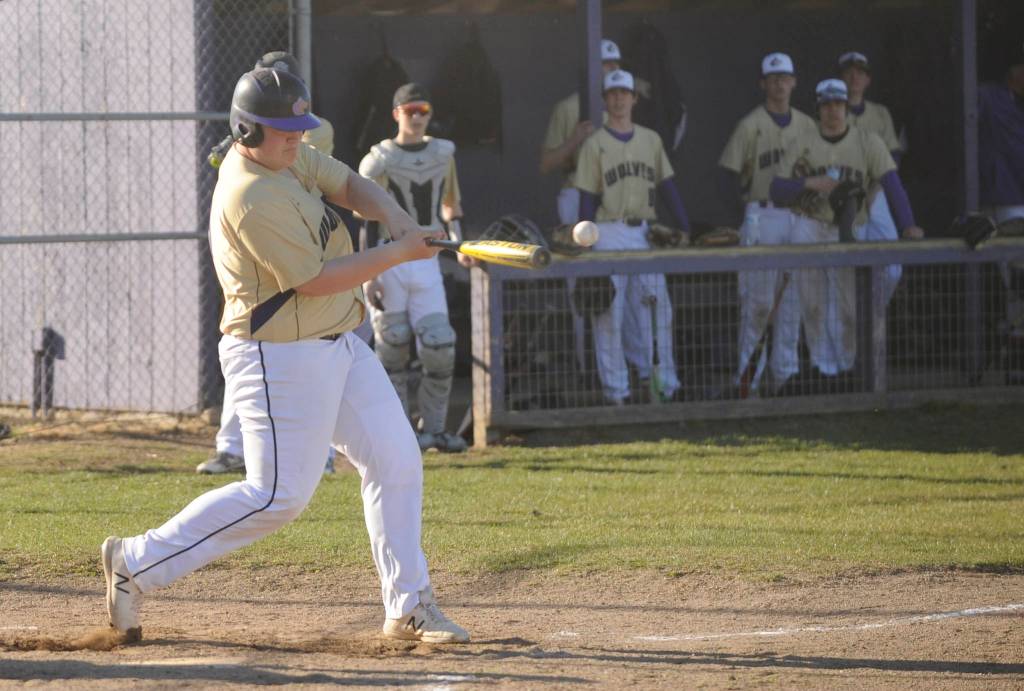 Sequim sophomore Caleb Pozernick gets into a pitch as the Wolves take on North Mason on March 20. Sequim Gazette photo by Michael Dashiell