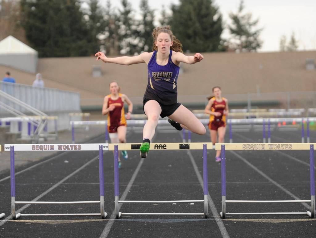 Sequim High sophomore Abby Schroeder wins the 300 meter hurdles with relative ease in a March 21 Olympic League meet in Sequim. Sequim Gazette photo by Michael Dashiell