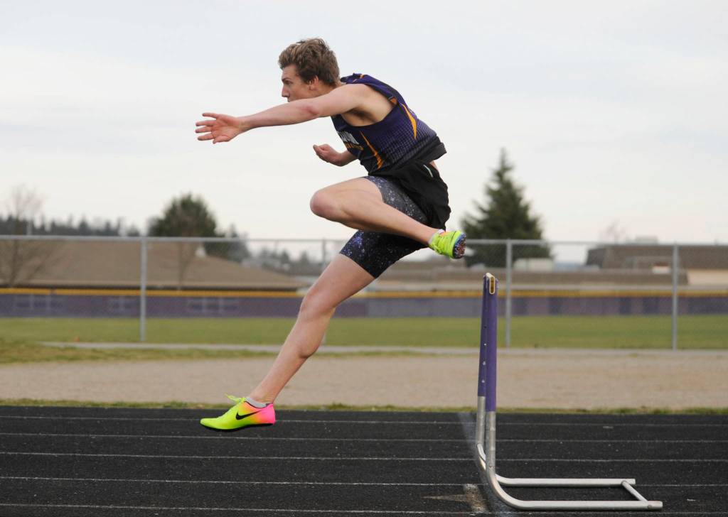 Sequim High senior Fischer Jensen cruises to a big win in the 300 meter hurdles on March 21. Sequim Gazette photo by Michael Dashiell