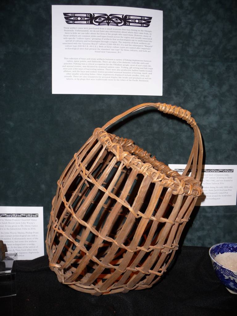 The tribal library has numerous artifacts on display, including this hand-woven clam basket from the 1940s. Sequim Gazette photo by Patricia Morrison Coate