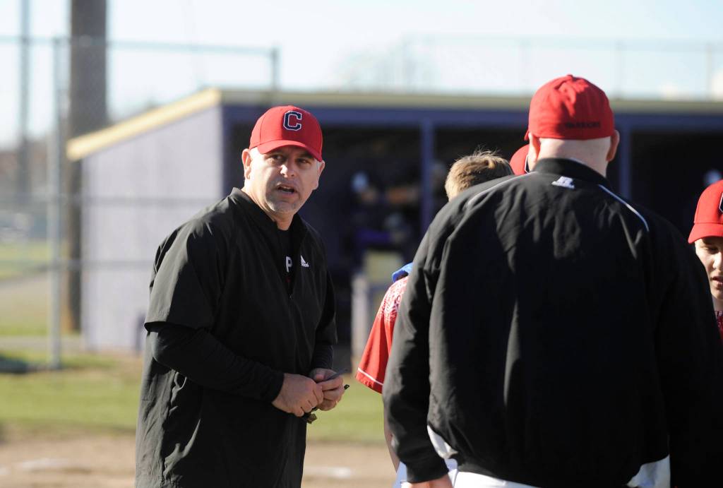 Former Sequim High standout Derrin Doty, left, talks with his Crosspoint Warriors team in a non-league match-up in Sequim on March 26. Doty earned a scholarship to play at the University of Washington and was drafted by the Angels in 1993 as an outfielder. Sequim Gazette photo by Michael Dashiell