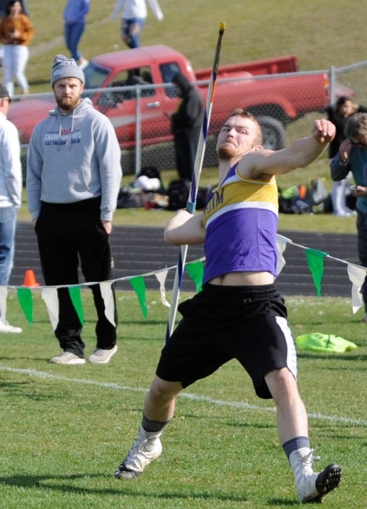 With cousin Riley Cowan looking on, Ben Cowan rears back and throws in the javelin competition at last weeks invitational track meet in Port Angeles. Ben Cowan placed seventh in the event with a 117-4 effort. Sequim Gazette photo by Michael Dashiell