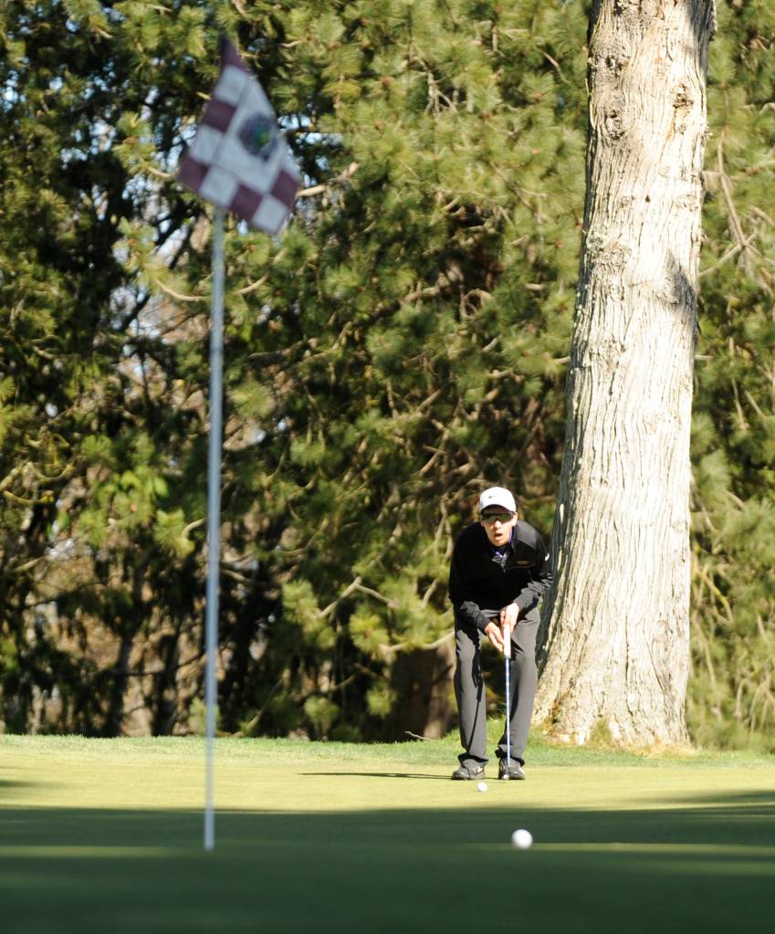 Sequims Blake Wiker lines up a putt in the Wolves March 26 win over Kingston at The Cedars at Dungeness. Sequim Gazette photo by Michael Dashiell