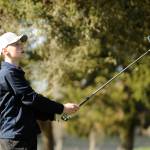 Dominic Riccobene watches a drive on the 11th hole at The Cedars at Dungeness on March 26. The freshman shot a nine-hole round of 45 as the Wolves topped Kingston by 52 shots. Sequim Gazette photo by Michael Dashiell