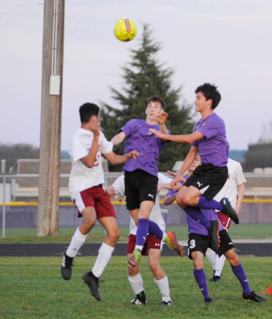Sequims Eli Gish, center, and Sean Weber, right, look to get a head on the ball in the Wolves 4-2 home victory over Kingston on March 28. Sequim Gazette photo by Michael Dashiell