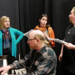 From left, director Christy Holy, Steven Humphrey (on piano), Emma Jane Garcia and Austin Krieg work on a duet in the wings during rehearsal for Olympic Theatre Arts First Date. Photo courtesy of Olympic Theatre Arts
