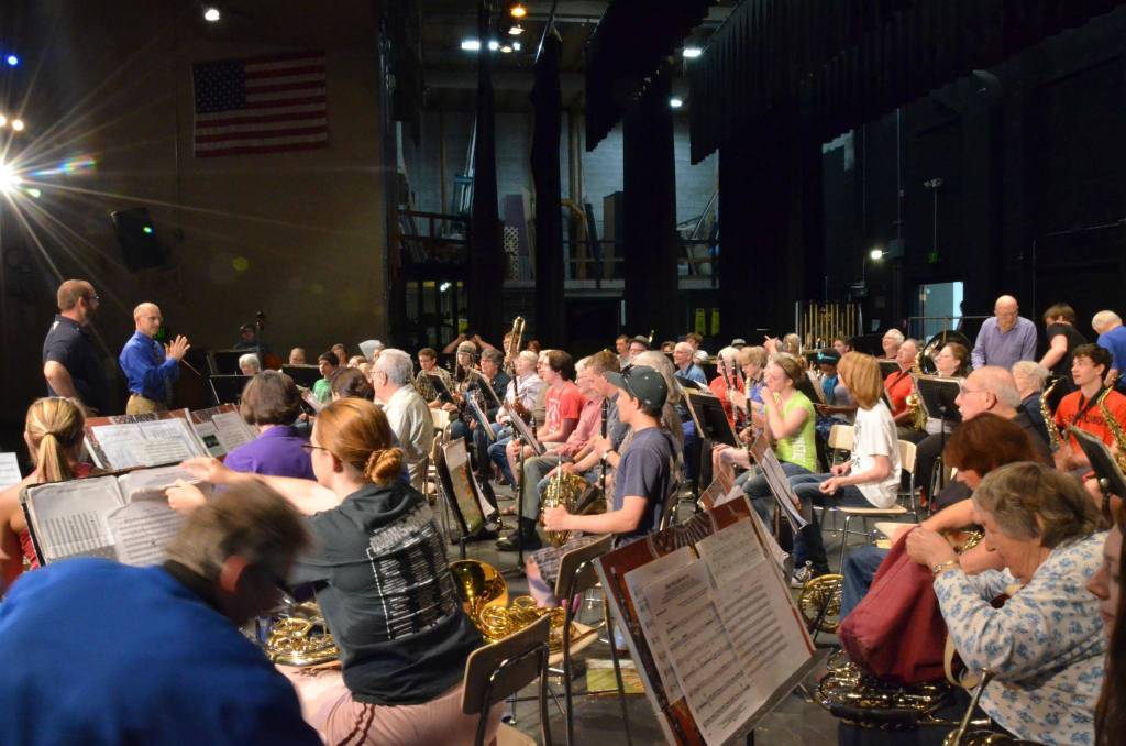 Tyler Benedict and Doug Gailey prepare the combined Sequim City Band-Port Angeles High School Wind Ensemble band during a dress rehearsal for a concert in May 2014. Photo courtesy of Sequim City Band