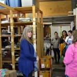 During a walking tour of some of Sequims many small businesses, Kathy Greenwald, operations manager for Pondicherri/handprint, offers a behind-the-scenes look at the wholesale side of the business to U.S. Small Business Administration Seattle District Director Kerrie Hurd and others on March 28. Sequim Gazette photo by Matthew Nash