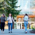 Sequim students Isabella Dennis and Bobbi Sparks walk along Peninsula Colleges campus recently. Currently, Sequim High School has 91 Running Start students attending both high school and college courses between Sequim and Port Angeles. A recent decision to cut 15 positions due to an $800,000 deficit due to shrinking enrollment may decrease the number of class offerings for college students. Photo by Jesse Major/Olympic Peninsula News Group