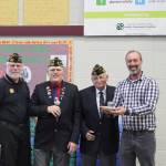 From left, Carlsborg VFW representatives Tom Fenner, Rod Lee and Joe Borden present Aaron Reno with their VFW Teacher of the Year Award. Photo by Darcy Lamb