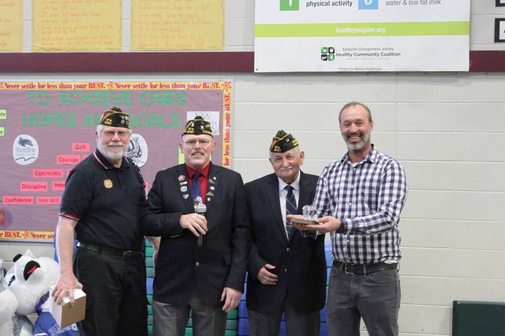 From left, Carlsborg VFW representatives Tom Fenner, Rod Lee and Joe Borden present Aaron Reno with their VFW Teacher of the Year Award. Photo by Darcy Lamb