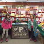 Olympic Peninsula Academy second-graders Gabby Terry and Josephine Johnson take part in OPAs Scholastic Book Fair. Submitted photo