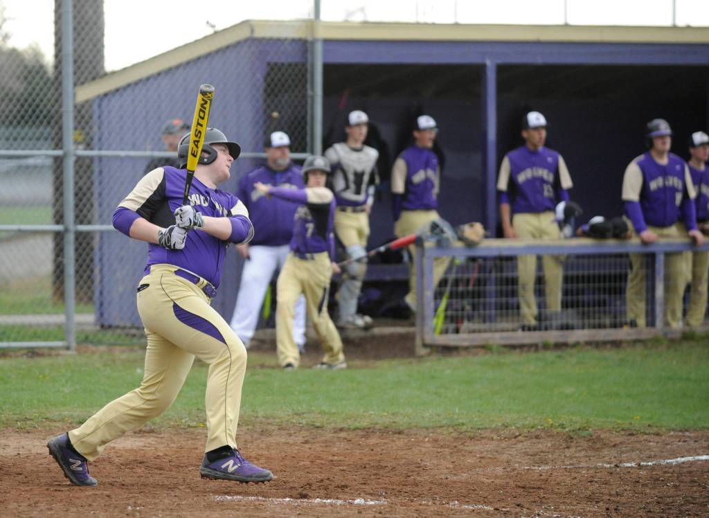 Sequims Brandon Barnett notches a base hit in the Wolves 13-3 win over Olympic on April 12. Sequim Gazette photo by Michael Dashiell