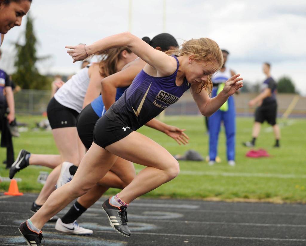 Sequim High freshman Riley Pyeatt gets a good break from the starting line at an Olympic League meet in Sequim on April 11. Pyeatt set a personal best with a 13.12-second finish in the event. She went on to win the 200- and 400-meter races as well. Sequim Gazette photo by Michael Dashiell