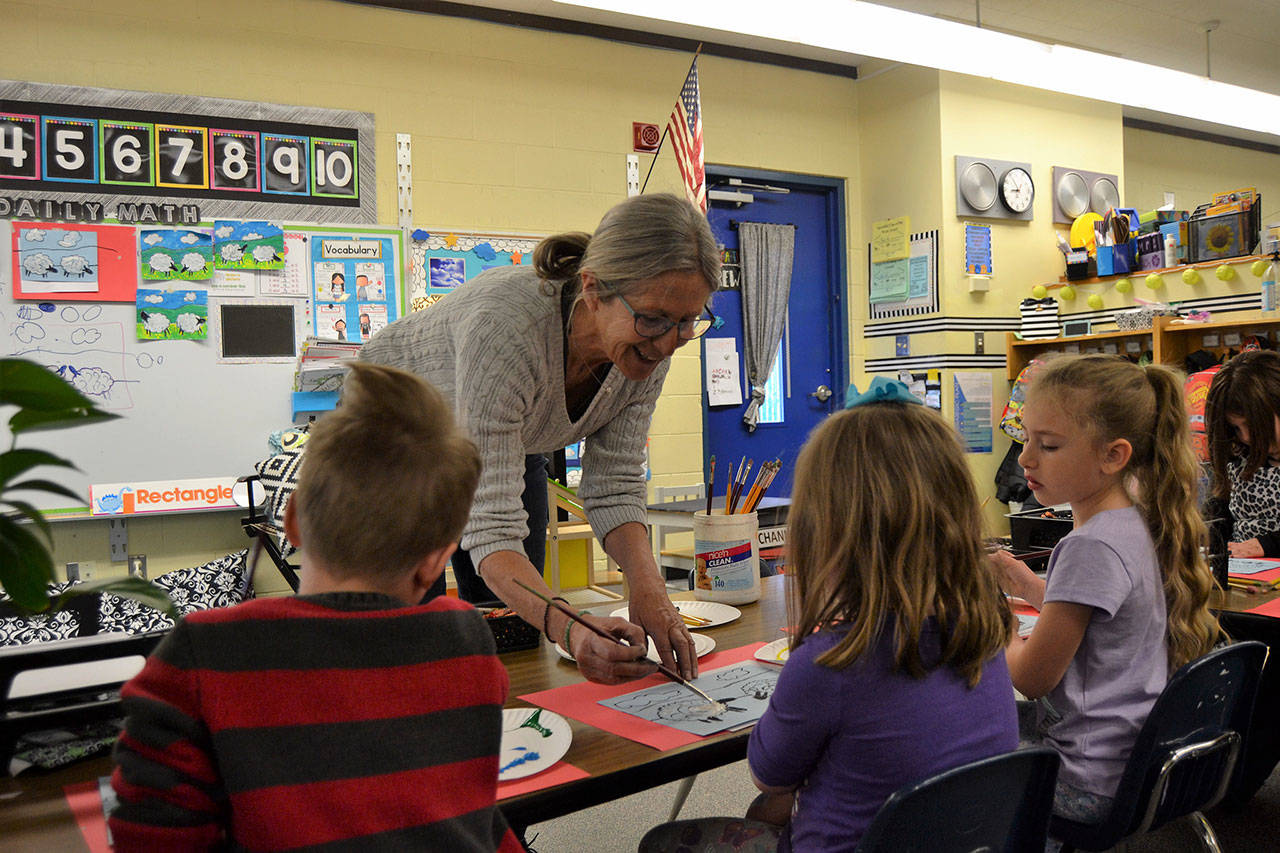 Helen Haller Elementary kindergartners in Stephanie Grotzke-Nashs class listen in for advice from Carrie Rodlend about how best to paint a sheep. When shes not teaching art in classrooms, Rodlend works with children and adults in Dungeness making art. Her latest show on April 20 at 562 Holgerson Road focuses on land- and seascapes. Sequim Gazette photo by Matthew Nash