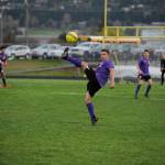 Sequims Mathys Tanche, center, looks to deflect a free kick from Port Angeles Kaleb Baier in the Wolves 1-0 win on April 9. Sequim Gazette photo by Michael Dashiell