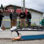 FREDS Guns owner Seth Larson talks to Clallam County Sheriffs detectives after someone drove a loader through his store and stole about 20-30 handguns. (Jesse Major/Peninsula Daily News)