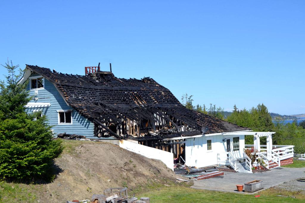 Fire officials with Clallam County District 3 believe a fire in this Gardiner home started in the attic from a wood stoves connection to the roof causing the southeast portion of the home to burn. Sequim Gazette photos by Matthew Nash