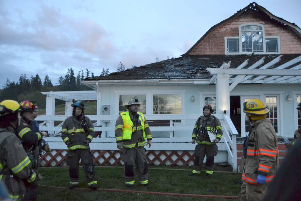 Fire Chief Ben Andrews with Clallam County Fire District 3 addresses firefighters from multiple agencies after they initially put out a fire in a Gardiner home on April 26. The fire rekindled early the next morning causing much of the remaining home to be lost, family members said. Sequim Gazette photo by Matthew Nash