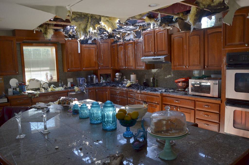 Fire began to spread into the front portion of this Gardiner home on April 26 until firefighters were able to contain it. Sequim Gazette photo by Matthew Nash