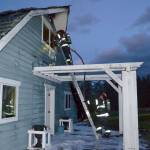 Port Ludlow Fire and Rescue firefighters look for hotspots on Friday night in a Gardiner home on the 2000 block of Old Gardiner Road. Sequim Gazette photo by Matthew Nash