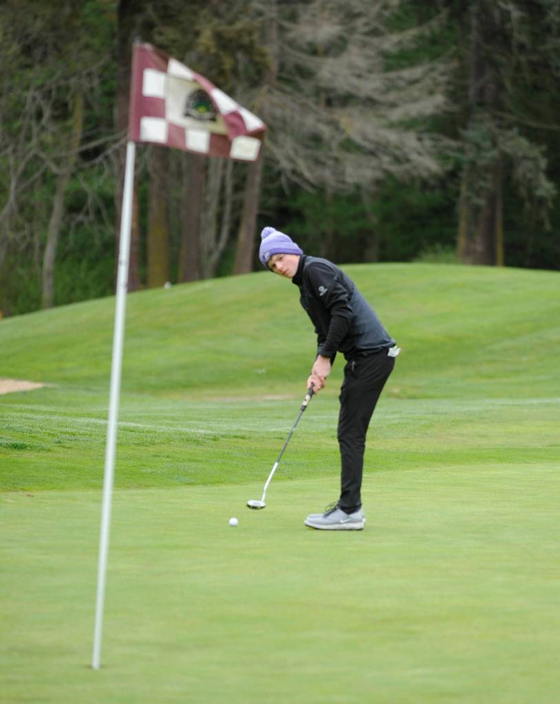 Sequim High freshman Ben Sweet looks to sink a putt on the first hole at The Cedars at Dungeness last week. Sequim Gazette photo by Michael Dashiell