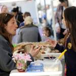 Jenna Ziogas, education coordinator at the Dungeness River Audubon Center, talks about birds beaks with Elyse Kim of Sequim at the 2017 Family Fun Day. The event continues 9 a.m.-4 p.m. on Washington Street on May 4. Sequim Gazette file photo by Michael Dashiell