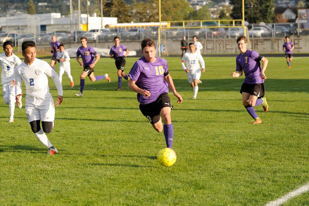 Mathys Tanche drives through North Mason players to help the Wolves win 7-0. Sequim Gazette photo by Matthew Nash