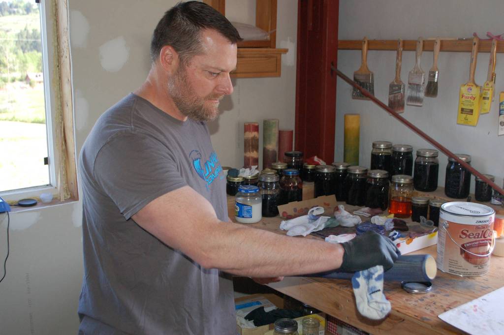 Gary White applies the dye to a Tsunami Bat. Sequim Gazette photo by Conor Dowley