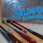 Several finished Tsunami Bat Company bats on display with the Sequim companys sign. Sequim Gazette photo by Conor Dowley.