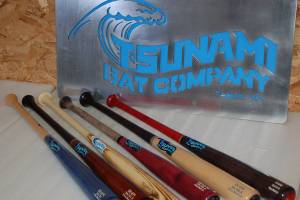 Several finished Tsunami Bat Company bats on display with the Sequim companys sign. Sequim Gazette photo by Conor Dowley.