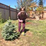 Isaac Stromberg stands by a tree that volunteers planted in his honor at his grandmothers house. The home will soon house women and families facing trauma and crisis. Photo courtesy of Laraine Claire