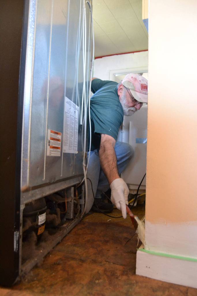 Harry Damian with St. Josephs Catholic Church in Sequim paints behind a fridge in a home on April 27 as part of Sequim Beautiful Day. Damian said his wife Eileen recruited him to help with the project that will help women and families facing crisis and trauma. Sequim Gazette photo by Matthew Nash