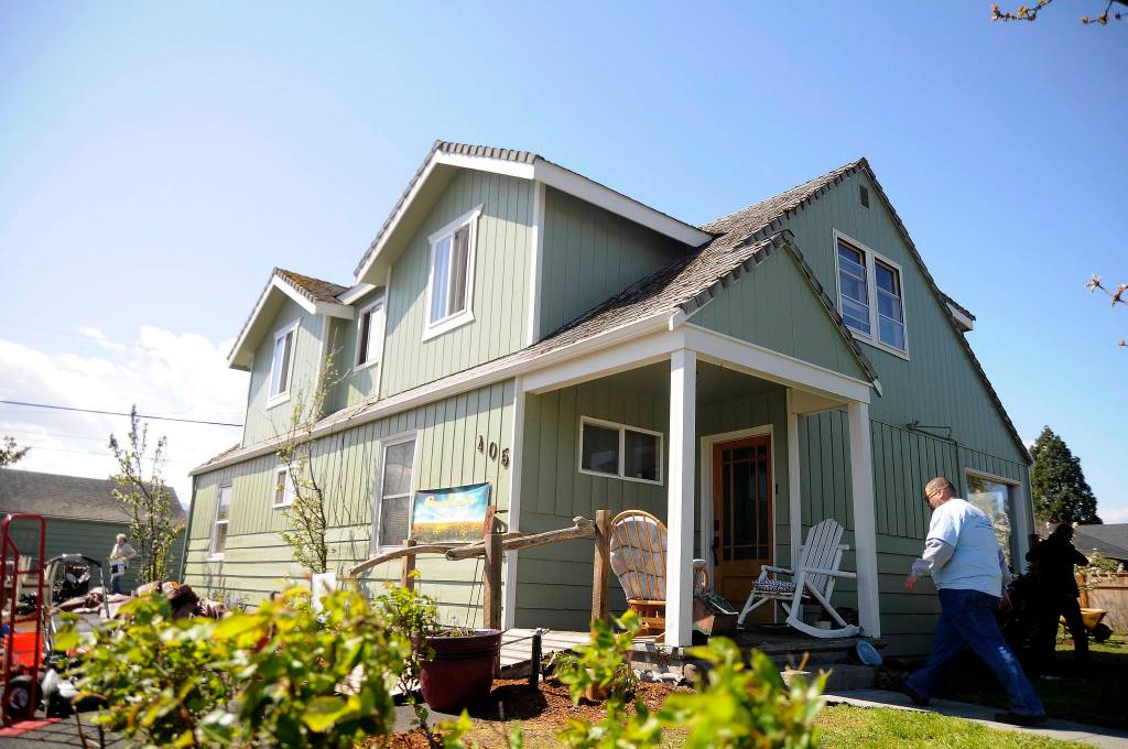 Manny Aybar walks into a home at Fourth Avenue and Spruce Street that volunteers help clean up, one of several 2019 Beautiful Day projects throughout Sequim on April 27. Sequim Gazette photo by Michael Dashiell