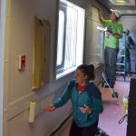 Jennifer and Charles Cox with Sequim Community Church help paint a classroom at the Olympic Peninsula Academy on April 27 for Sequim Beautiful Day.
