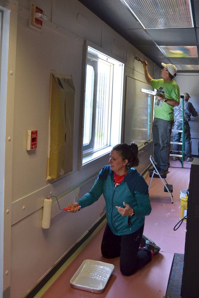 Jennifer and Charles Cox with Sequim Community Church help paint a classroom at the Olympic Peninsula Academy on April 27 for Sequim Beautiful Day.