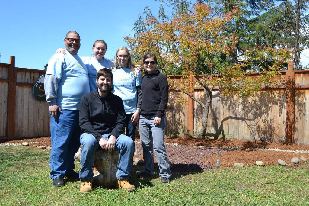 From left, volunteers Manny Aybar, executive director of ORCA, Our Community Resiliency Alliance, Krista Baker, Keith Sandell, youth pastor for Sequim Community Church, Cassidy Crecelius and Brittany Van Ness stand together after completing a prayer garden at the future home of ORCAs site for women and families facing crisis and trauma. Sequim Gazette photos by Matthew Nash