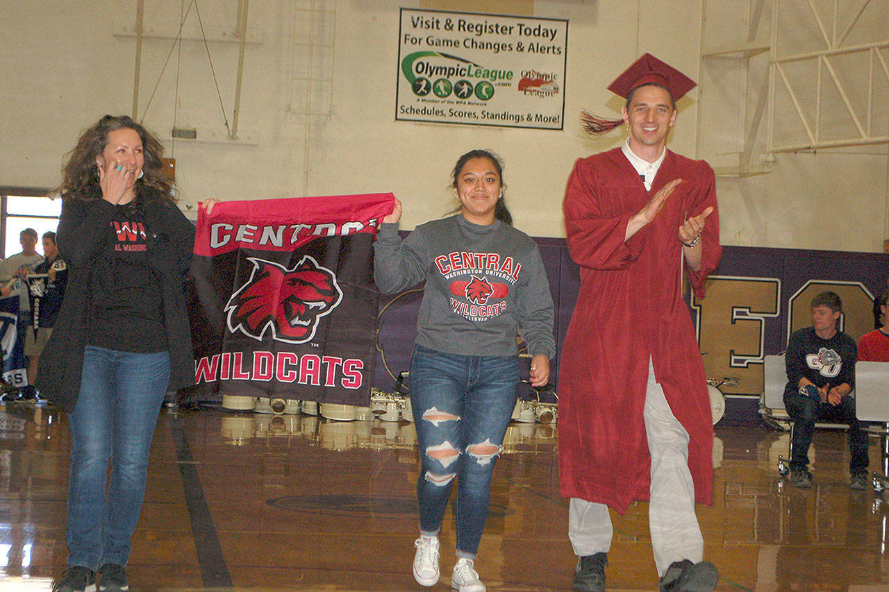 Sequim High School teacher Sean OMera walks with future Central Washington University student Nathalie Torres during SHS inaugural Decision Day assembly. Sequim Gazette photos by Conor Dowley.