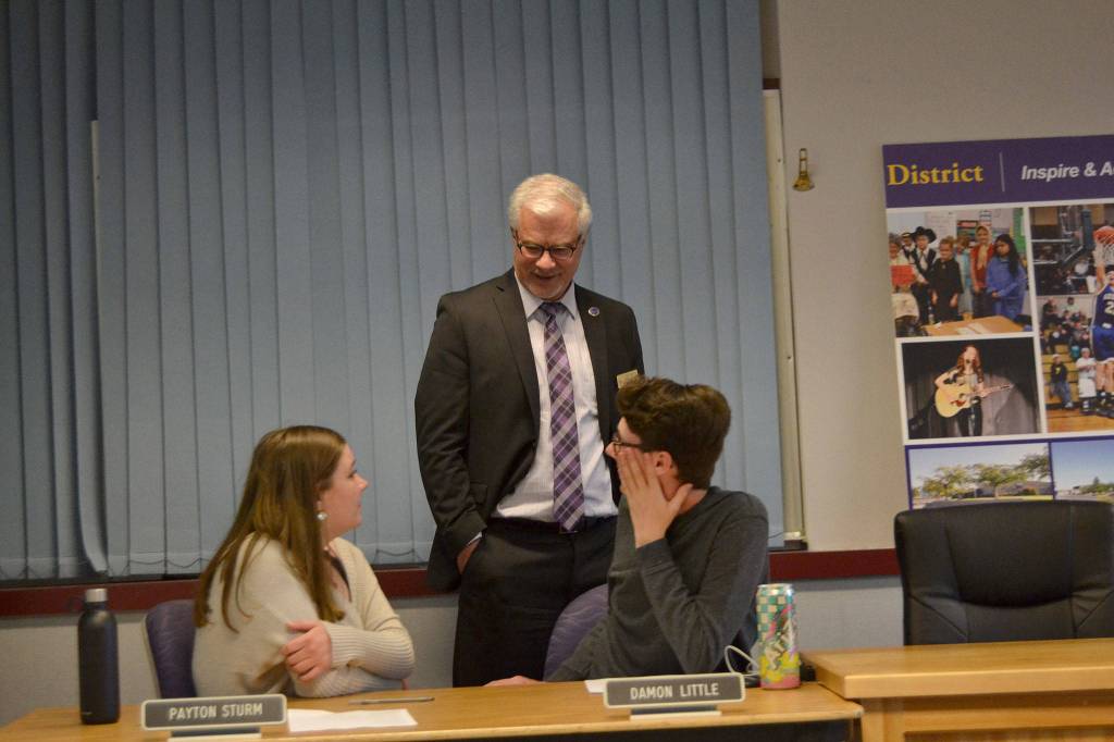 Gary Neal, Sequim Schools superintendent, speaks with student representatives Payton Sturm and Damon Little during a break of the Sequim School Board. That night, May 6, board directors approved Neals resignation. Sequim Gazette photo by Matthew Nash