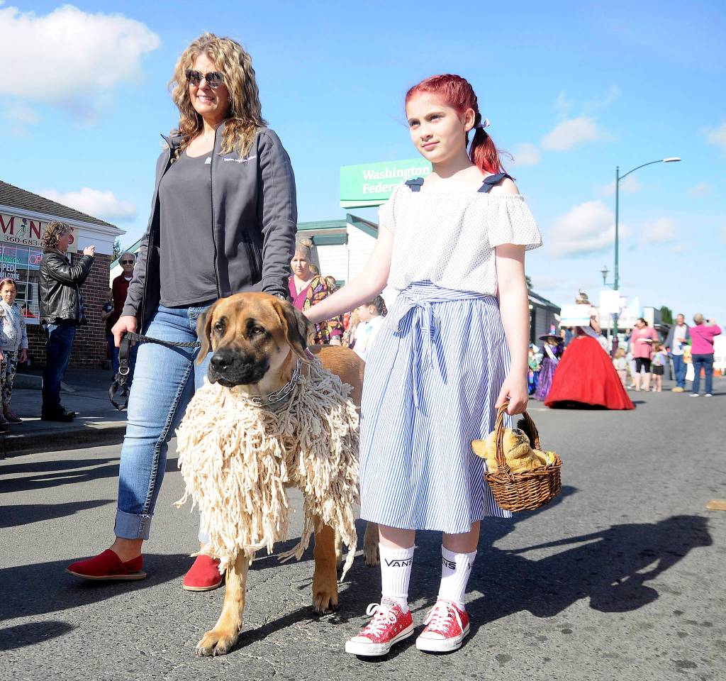 Dressed up as characters from The Wizard of Oz to go along with the Irrigation Festivals 2019 theme, Theres No Place Like Home, Glenna Krieger, right, and Sheriff take part in Saturdays Kids parade, joined here by Sarah Cary-Krieger. Sequim Gazette photo by Michael Dashiell