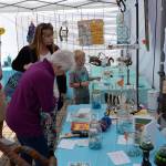 Visitors of the Innovative Arts and Crafts Fair make careful decisions as they vote for their favorite art pieces for the Reuse Showcase. Sequim Gazette photo by Matthew Nash