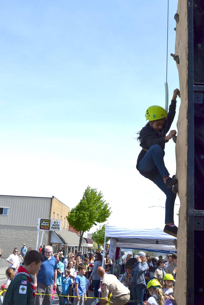 Ayat Awawdeh, 9, of Sequim, climbs high on the wall provided by Sequim Scout troops and packs during the Family Fun Day. Children lined up throughout May 4 to climb courtesy of BSA Scout Troop 1498, Venture Troop 2223 and Cub Scout Pack 4850. Sequim Gazette photo by Matthew Nash