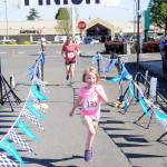 Sequims Eleanor Jones edges mom Laura Gould at the finish line of the 1-mile version of the 2018 Irrigation Festival Fun Run. It was Jones first road race. Sequim Gazette file photo by Michael Dashiell
