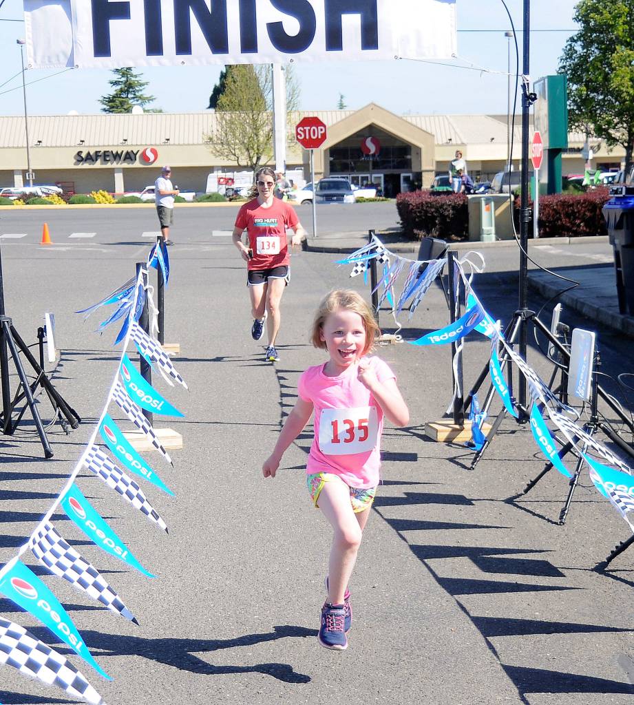 Sequims Eleanor Jones edges mom Laura Gould at the finish line of the 1-mile version of the 2018 Irrigation Festival Fun Run. It was Jones first road race. Sequim Gazette file photo by Michael Dashiell