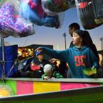 Blake Bacchus makes a throw in the ring toss as his brothers Nolan and Roman wait their turn at the 2018 carnival. It continues this year May 9-12. Sequim Gazette file photo by Matthew Nash
