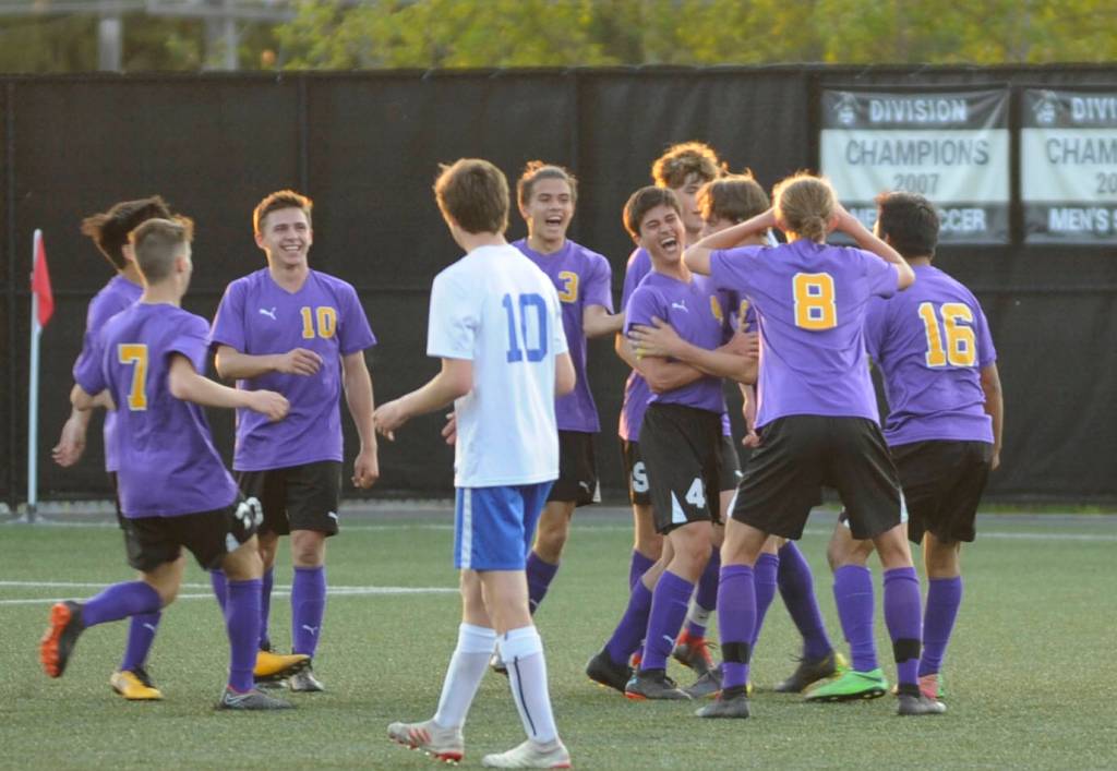Sequim teammates celebrate Sean Webers first half score in a 4-2 district playoff win over Washington on May 7. Webers was a key score, knotting the game at 2-2. SHSs Ryan Tolberd added a goal just before the halftime whistle to give the Wolves a 3-2 lead at intermission. Sequim Gazette photo by Michael Dashiell