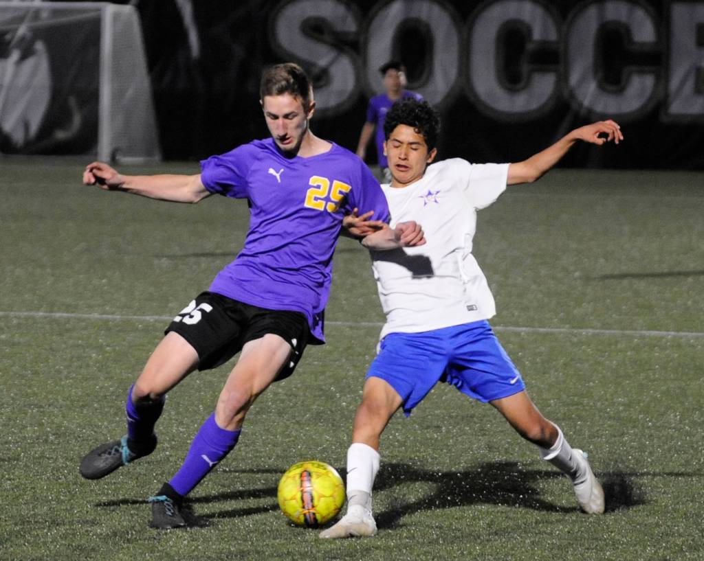 Sequims Brandon Wagner, left, and David Baltazar of Washington battle for control in the second half of Sequims 4-2 district playoff win on May 7. Sequim Gazette photo by Michael Dashiell